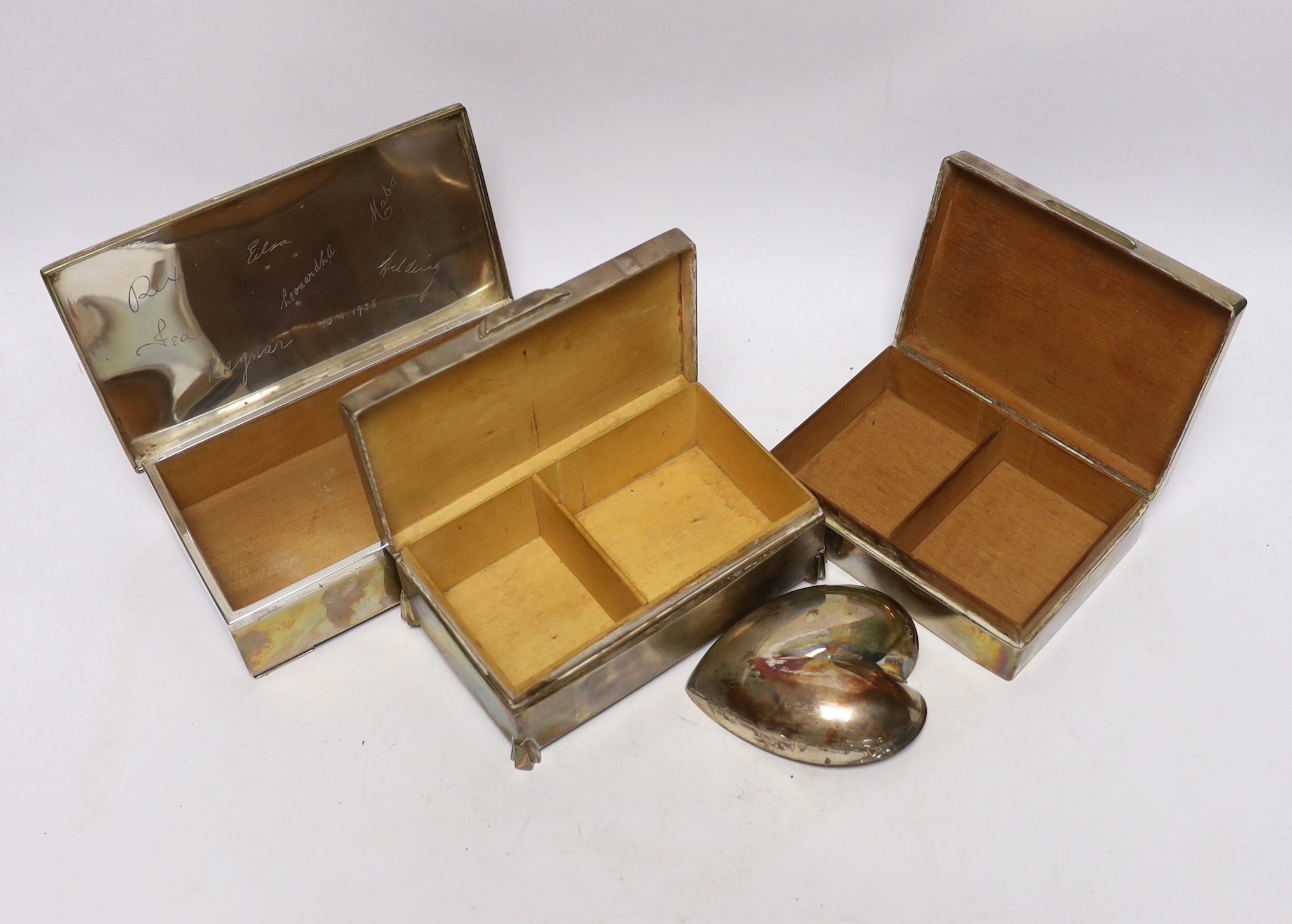 Two silver mounted cigarette boxes, including Art Deco, 15.2cm, together with a Finnish white metal mounted cigarette box and heart shaped dish.